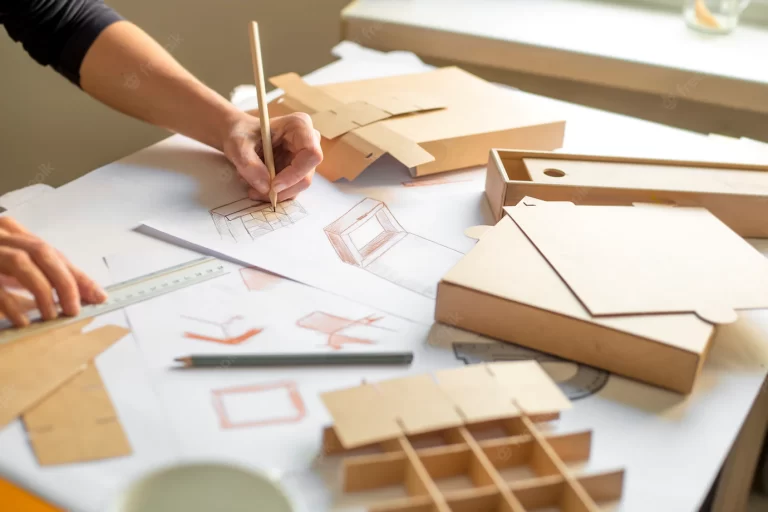 designer-draws-mockup-crafting-cardboard-box_8119-2284